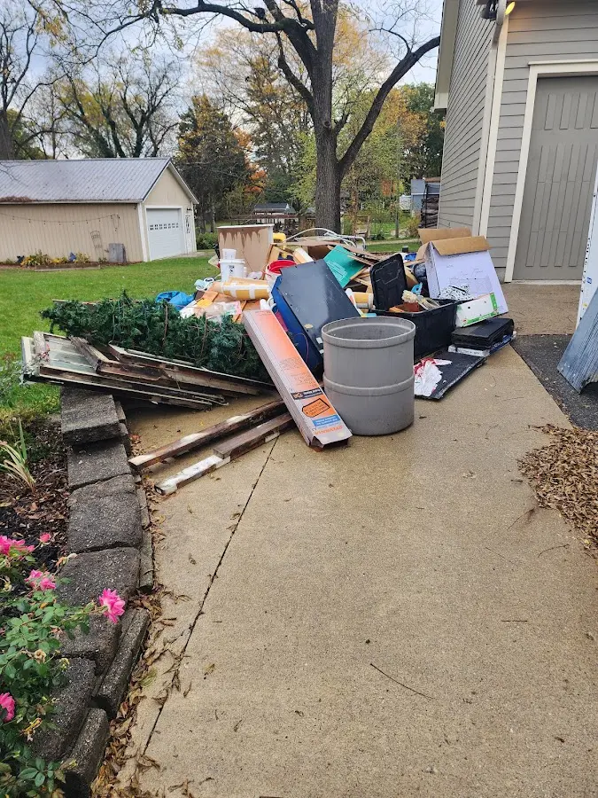 Dumpster being loaded with debris for Estate Cleanout Dumpster Rental in Baden